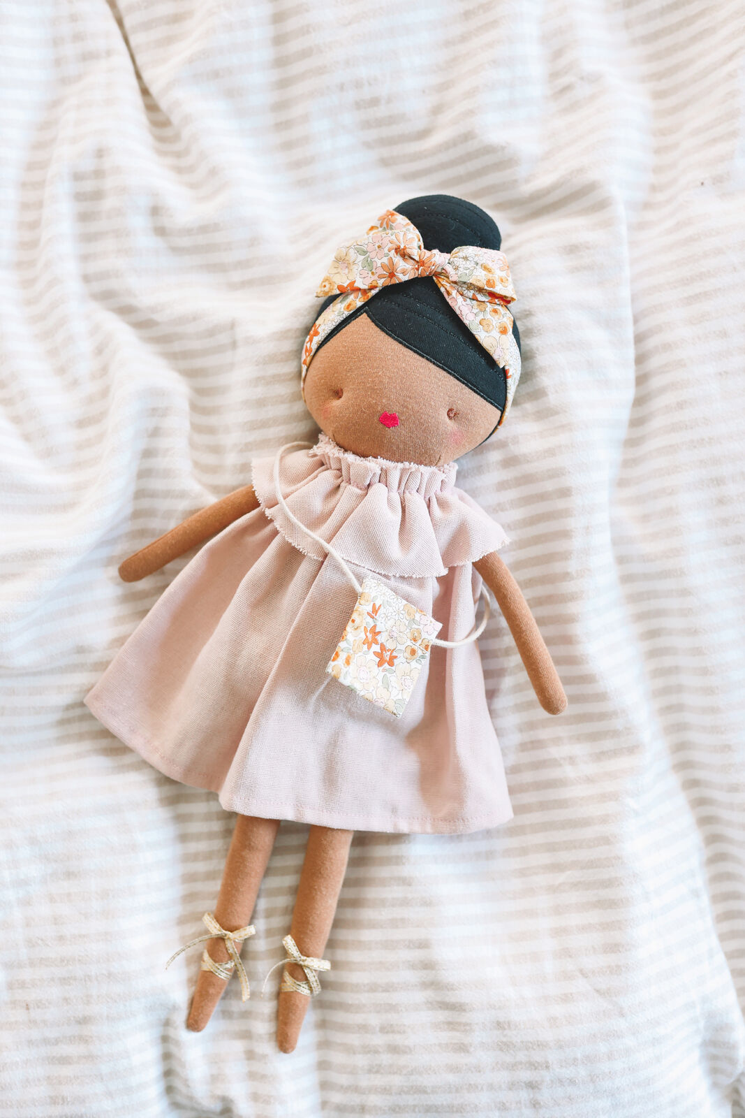 Piper is cute doll featuring a top knot hair style and perfectly accessorised with her head tie & bag. Suitable from 3yrs & up. Piper has a removable dress & bag, encouraging developmental play.Perfect gift for preschooler