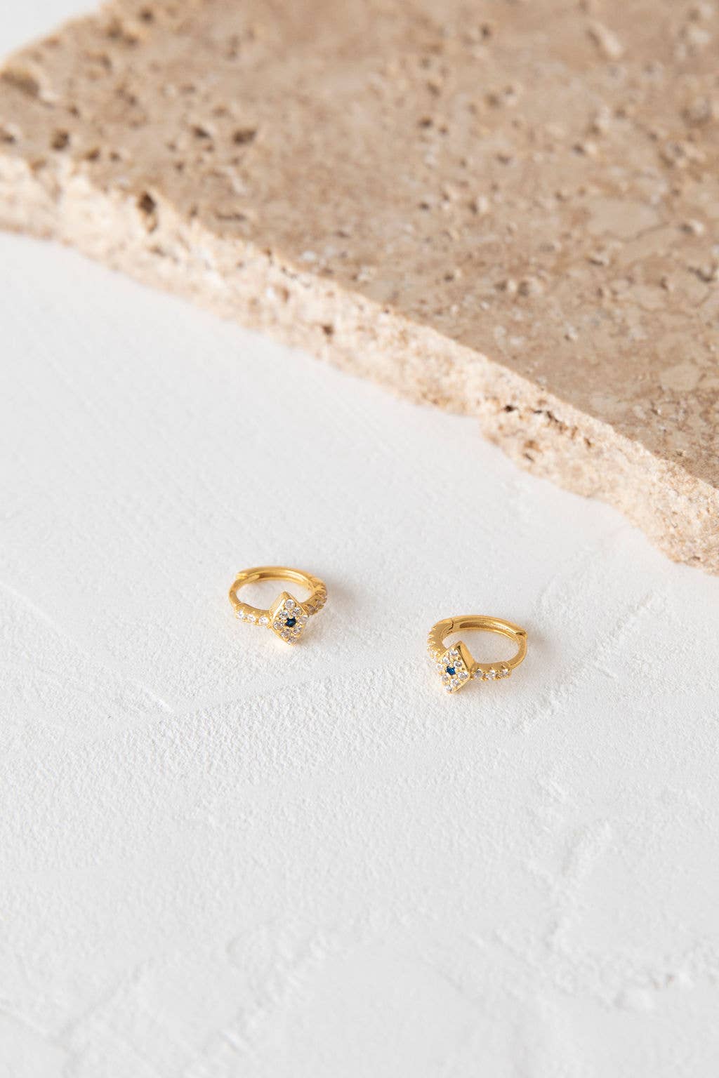 Evil Eye Talismans have been worn for centuries to protect against bad fortune.
This pair of earrings feature a crystal parve setting on a 10cm huggie earring. ~ Crafted from .925 Sterling Silver with a 18k Gold plating. 