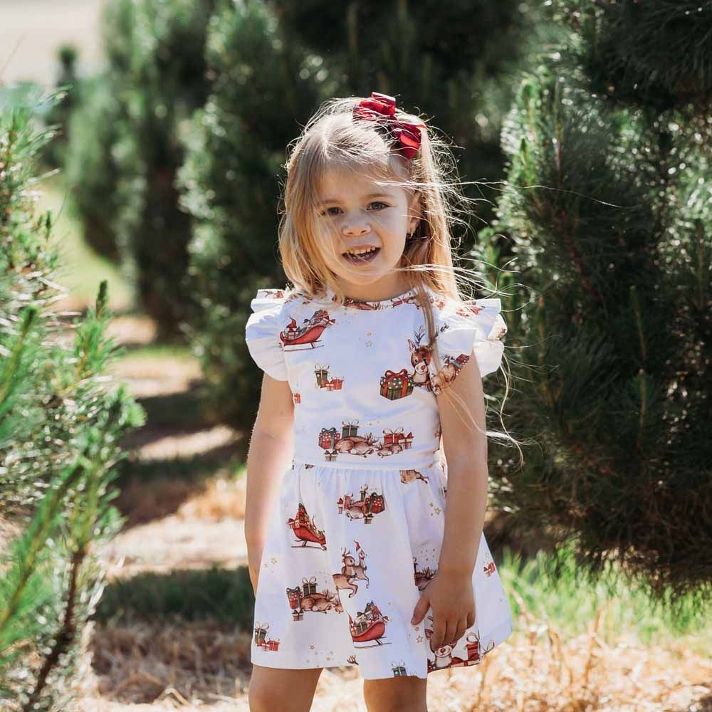 Reindeer Organic Dress  Features Include:  Exclusive Reindeer print Frill detail on shoulders Sleeveless Soft and stretchy Fitted bodice and flare skirt Easy to wear Lightweight and breathable GOTS Certified Organic CU 1182228 95% Organic Cotton / 5% Elastane