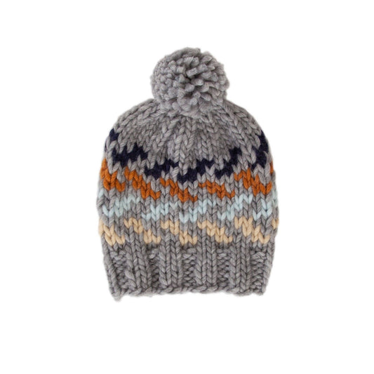 Adorable hand-knitted chunky beanie with a multi coloured zig zag pattern, a wide and comfy ribbing at the face and a cute pom pom on top.