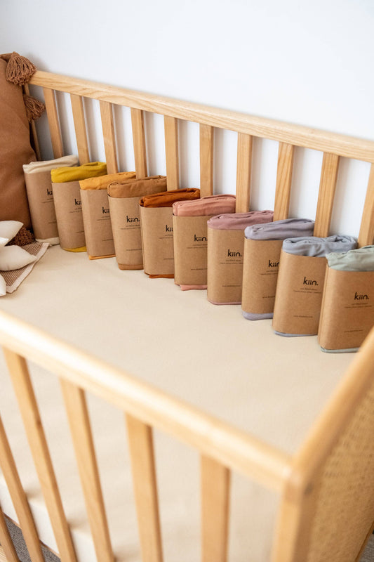 Kiin fitted sheets are made from the softest organic cotton + bamboo blend.  They are soft and gentle against delicate skin, laying smoothly beneath your little one; even through tosses and turns.