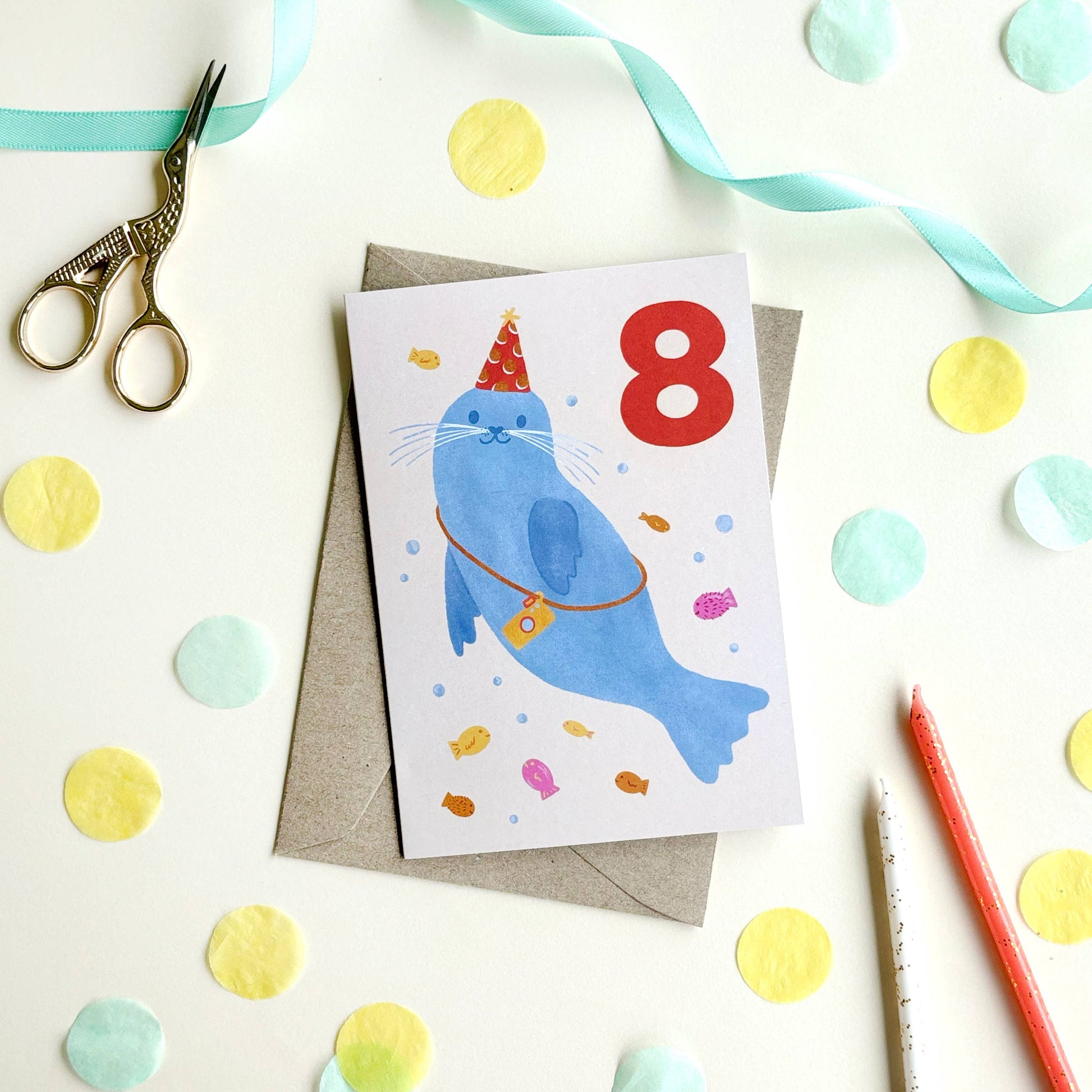 A bold hand-lettered number 8 sits on a soft beige background - the colour palette makes it a gender neutral greeting card, ideal for celebrating any child turning eight. Blank inside for a personal message