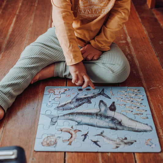 Our Ocean "Take Me With You" Puzzle is a stunning 36 piece jigsaw puzzle, packaged in the sweetest mini suitcase with a durable metal handle and latch.