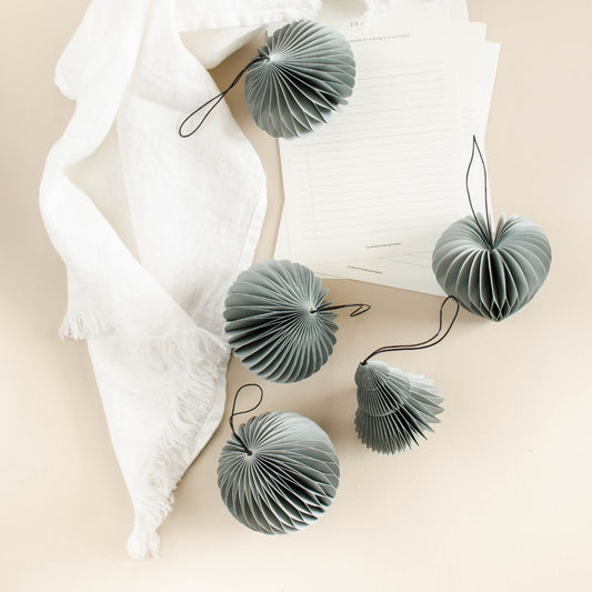 Handcrafted paper ornaments are back in new seasonal colours. Use the ornaments to decorate your Christmas tree, seasonal branches or your Christmas table. Choose your favourites from a variety of colours and shapes, and mix and match to get the perfect palette for your magical Christmas. After the festivities, the enclosed magnet enables you to fold and store the ornaments away neatly.