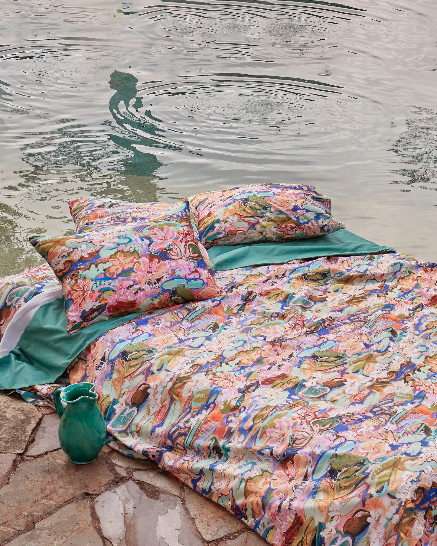  The Kip&Co x Kezz Brett Waterlily Waterway Organic Cotton Quilt Cover features a stunning painterly scene of water lilies and other pond blooming plants with layers of superb details in a spectrum of cool tone colours with plain green reverse.