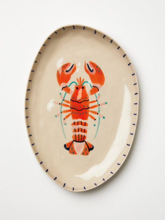 Infuse your home with the magic of the deep blue sea. With the Offshore Collection, you'll elevate your décor to new depths of style. Dive in, make a splash, and let this charming hand painted Lobster Tray transform your space into an aquatic wonderland.