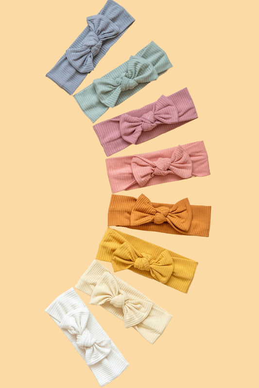 Made from the most luxuriously soft bamboo fabric, in a trendy ribbed texture. The fabric is incredibly soft, and super stretchy. With a removable bow, this also doubles as a plain headband. Perfect for newborns, infants & toddlers.