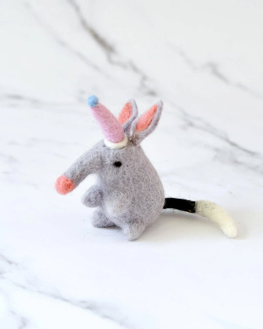 How adorable is this Felt Bilby Toy, which comes with a cute little party hat! Check out the needle-felted details on the ears and tail. Perfect for small world play and loose parts play.   Ethically hand-felted from 100% New Zealand wool Coloured with azo-free dye, safe for children and pets Height: 11cm Length: 6cm Weight: 15g