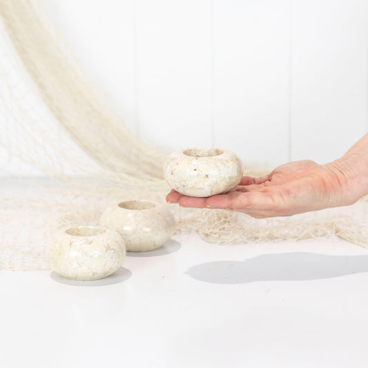These tea light candle holders has been made out of a creamy coloured stone!

A lovely addition to a sideboard or coffee table

As these are made from natural stone the colour, size and detail can vary a little. We will select for you from stock on hand at the time of purchase.

Measures approx: 7cm diameter x 4cm