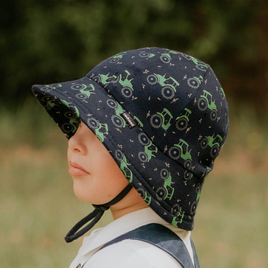 The Bedhead Toddler Bucket hat is a fabulous baby sun hat featuring a soft flexible brim and rated is UPF50+ Excellent Protection!

Our Toddler Buckets have a soft flexible brim that introduces babies and toddlers to an angled brim that frames their line of sight. All Bedhead hats are made from our super-stretchy and lightweight cotton jersey and come with a stretchy chin strap (if required, you can easily remove this without compromising the quality of the hat).

A best-seller in the making! This navy hat 