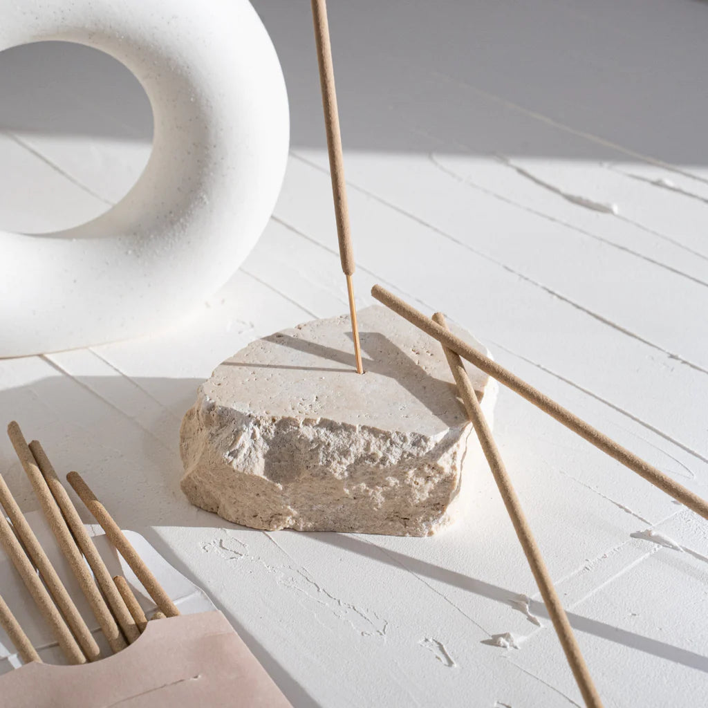 Our beautiful Incense Holder is designed to add refinement to your space as you burn your favourite scent. Each piece is handmade using natural travertine stone, which means no two pieces are the same. Designed to stand the test of time, this minimal design and timeless, natural colour is the perfect addition to any space.   Please Note: Because of the natural nature of these Incense Holders the colour and size will vary slightly between stones.