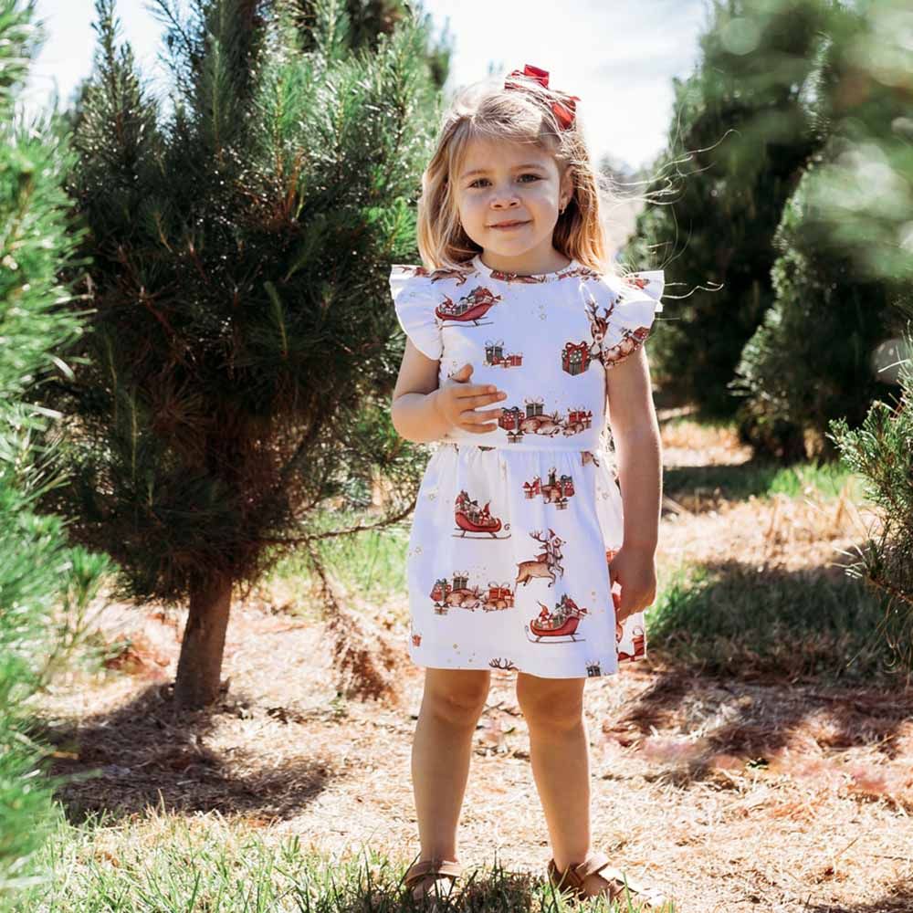 Reindeer Organic Dress  Features Include:  Exclusive Reindeer print Frill detail on shoulders Sleeveless Soft and stretchy Fitted bodice and flare skirt Easy to wear Lightweight and breathable GOTS Certified Organic CU 1182228 95% Organic Cotton / 5% Elastane