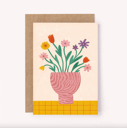 Illustrated vase of flowers greeting card, perfect for an anniversary, loved one or simply brightening someone's day. Colourful yellow, purple, red and pink flowers stand in a pink zebra vase, set against a check yellow tablecloth and beige background.  Blank inside for a personal message - A6 / 105 x 148mm