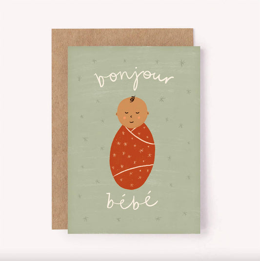 "Bonjour Bebe" (Hello Baby) greeting card, perfect for a baby shower or welcoming a new arrival.  Created in a gender neutral colour palette, with a green background, rust coloured baby wrap and white hand-lettered message with tiny stars scattered.  Blank inside for a personal message - A6 / 105 x 148mm